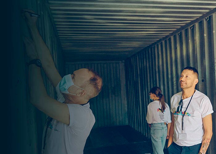 Four people in a container.