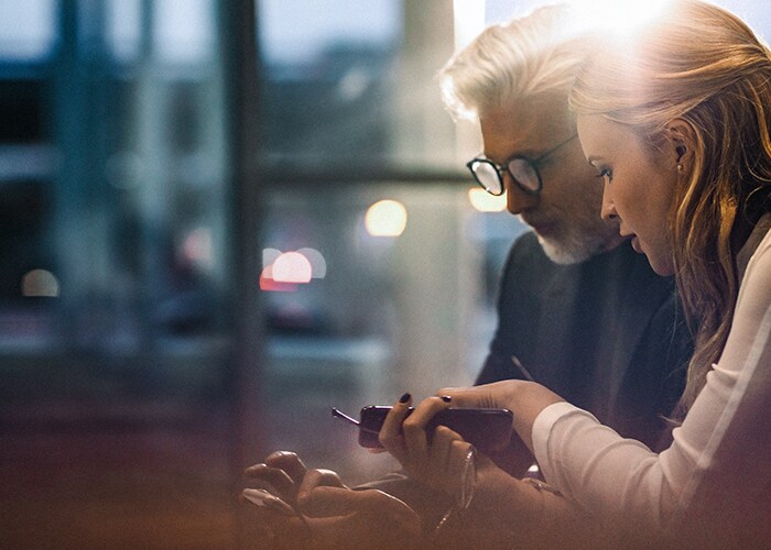 Two people are checking annual tax report