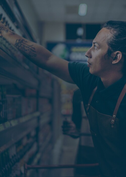 Male in a mart shelving products