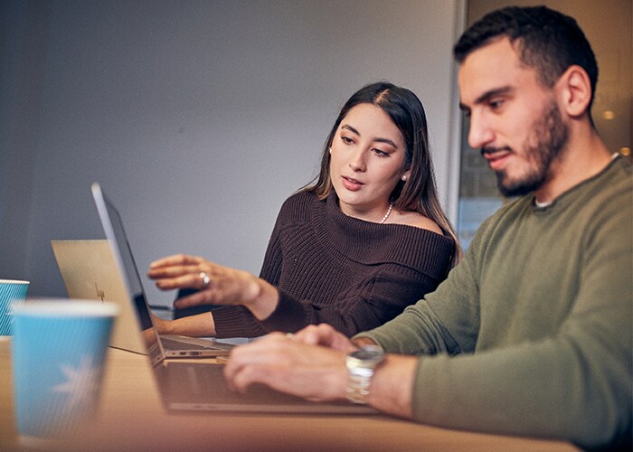 Male and Female employees are discussing about a project