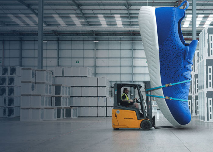 Forklift carrying big shoe