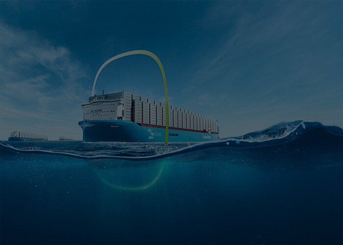 A Maersk ship on water, running on green methanol, carrying cargo containers.