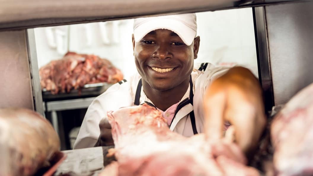 Butcher holding meat
