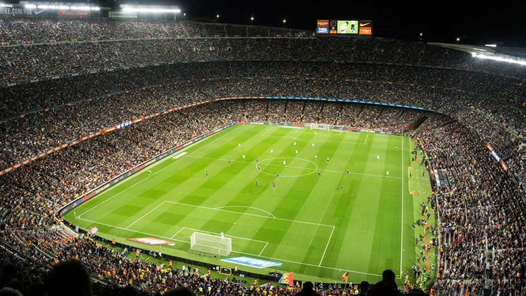 people watching soccer game in stadium