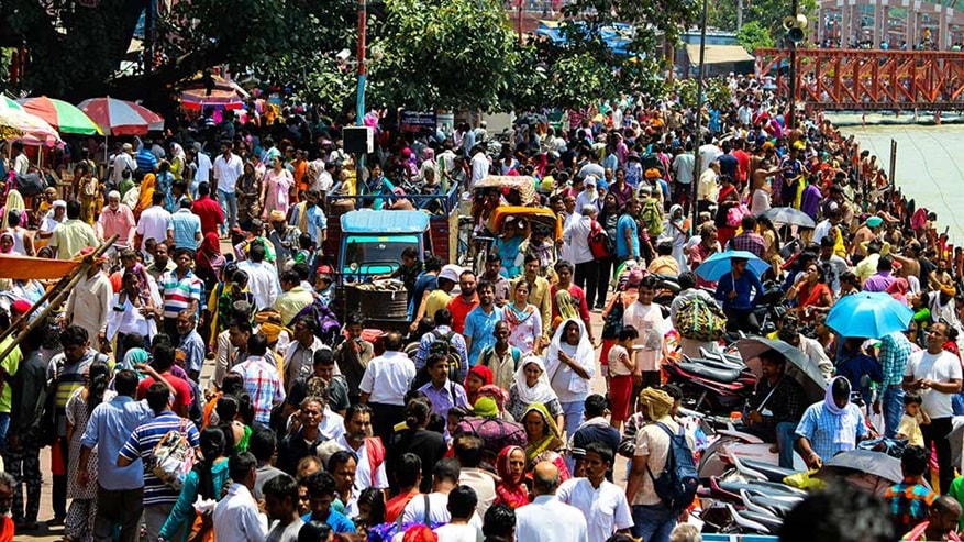 A crowd of Indian people in colourful clothing 