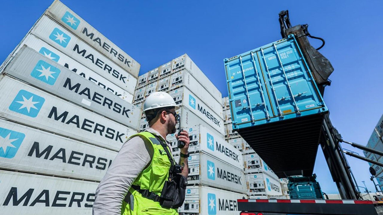 Maersk depot worker coordinating container handling at an inland container depot
