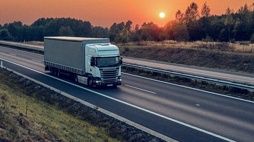 Truck on highway at sunset