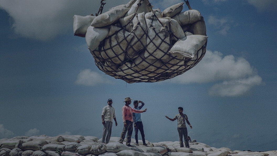 Emergency supply chain management – A group of men discussing about unloading the high-volume cargo.