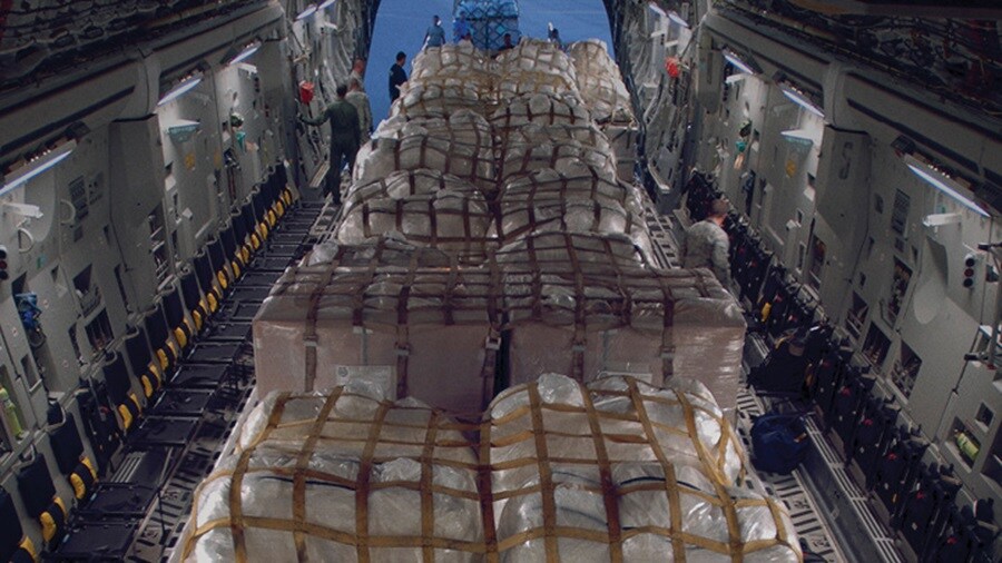 Emergency logistics solutions – Men unloading a large consignment of mosquito nets.