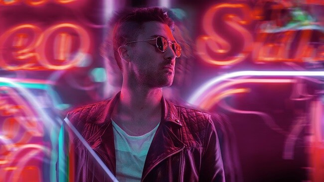 Man standing and background glowing text lights