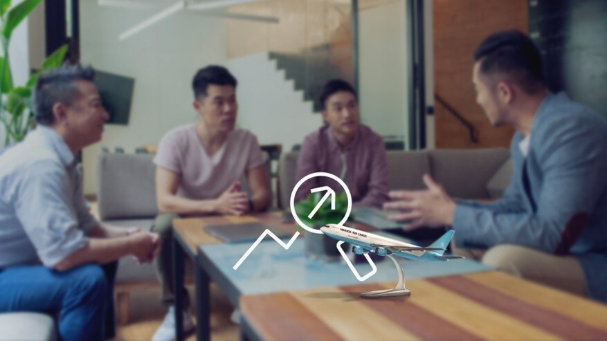Picture of four men sitting and discussing over an office like set up