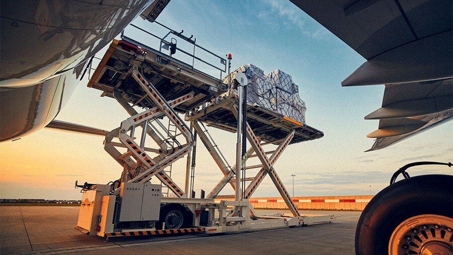 Close up shot or cargo getting loaded to a plane