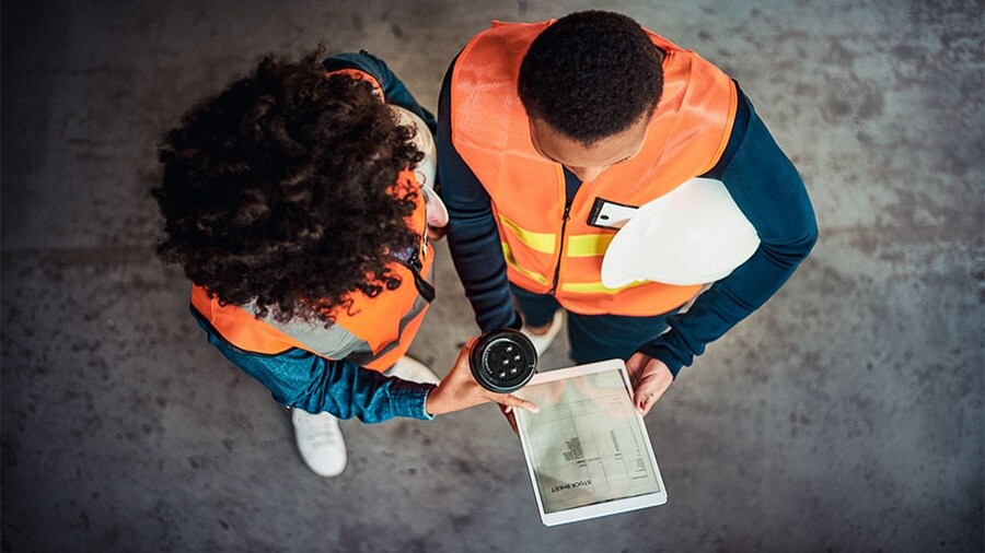 Eagle eye shot of a male and female looking into a tablet