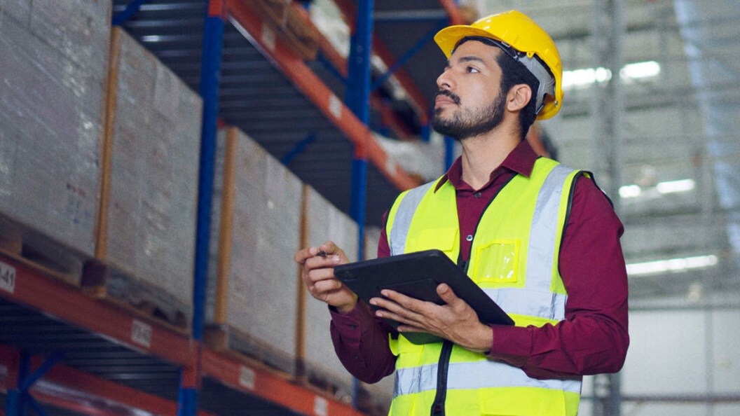 person holding tab in warehouse