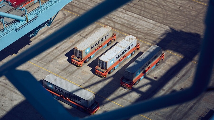 Maersk containers at a terminal before being loaded on a vessel.