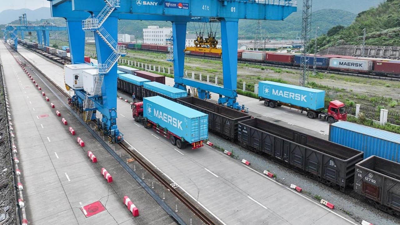 Maersk clue container being loaded on rail