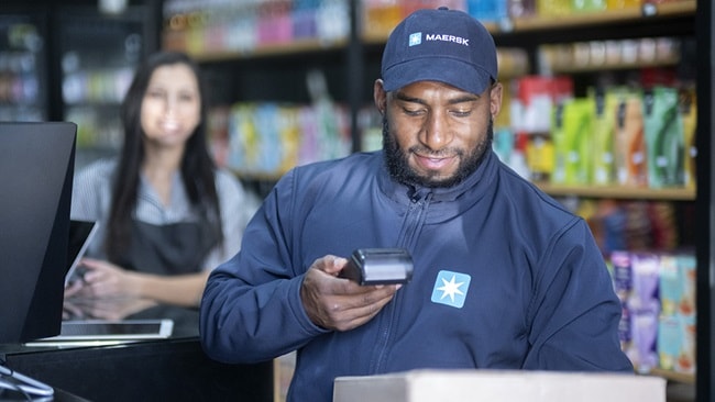 Maersk delivery person delivering orders to a commercial premises