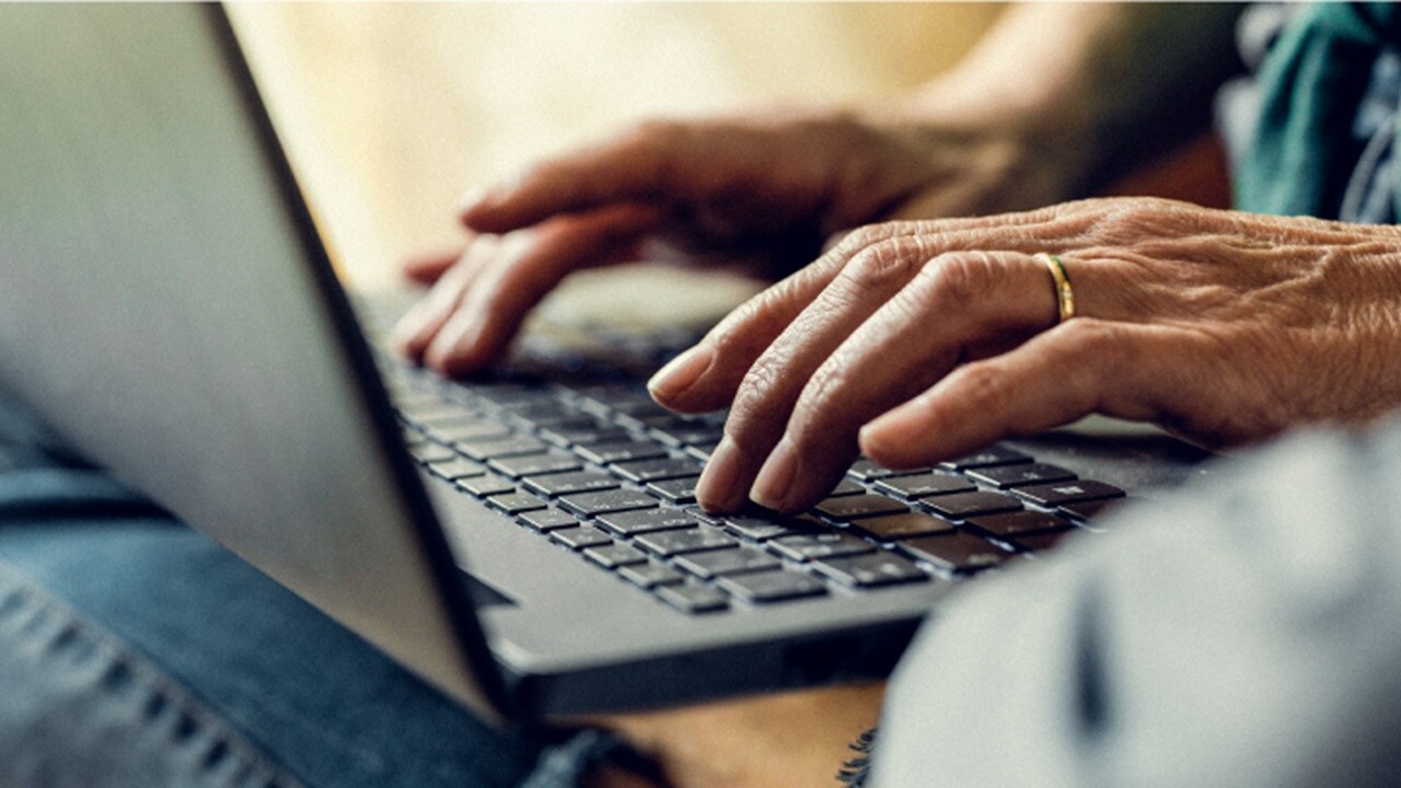 Close-up of hands typing on a laptop, to explore data integration solutions.