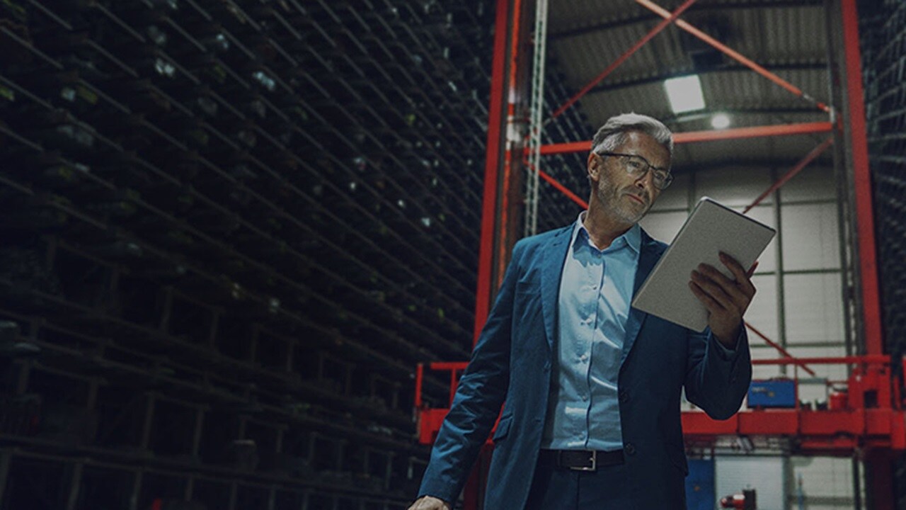 A man viewing the TradeLens notifications of shipments.