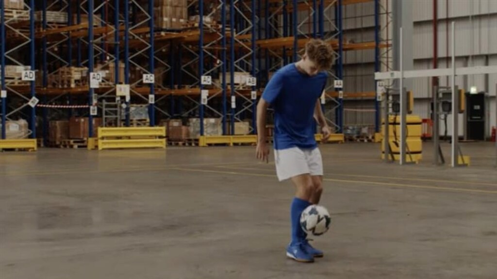 A male juggling with a football