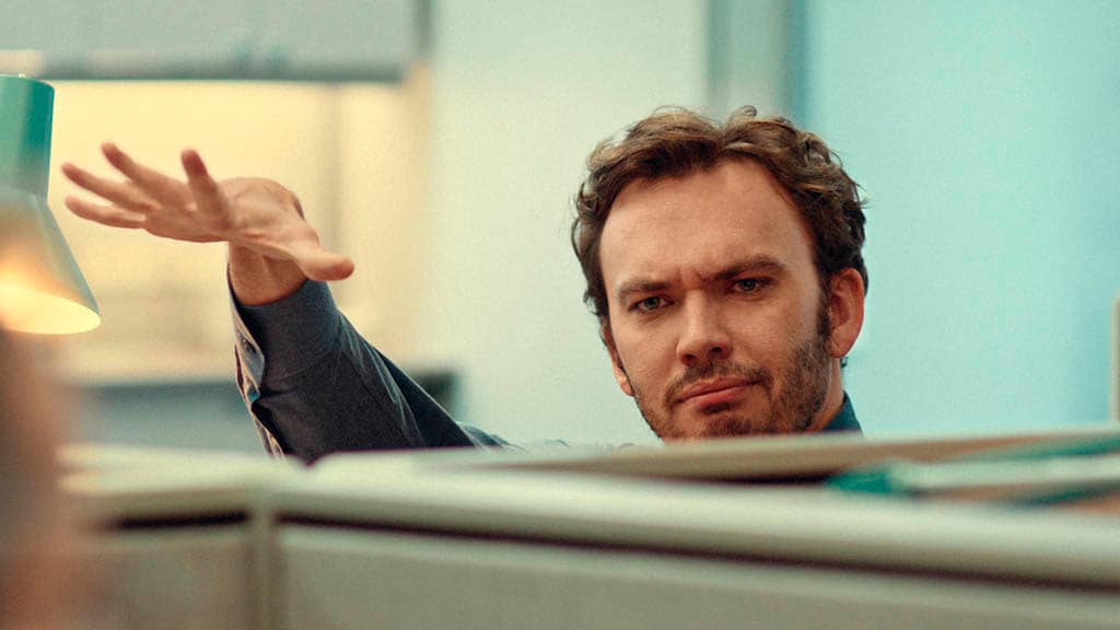 Business professional gesturing while communicating in a modern office environment