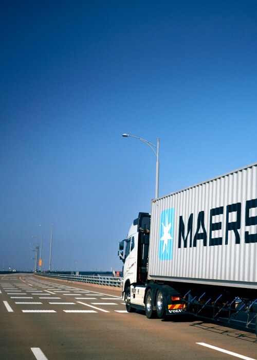 Image of a truck with a Maersk premium quality container with an extra layer of protection for safeguarding goods.